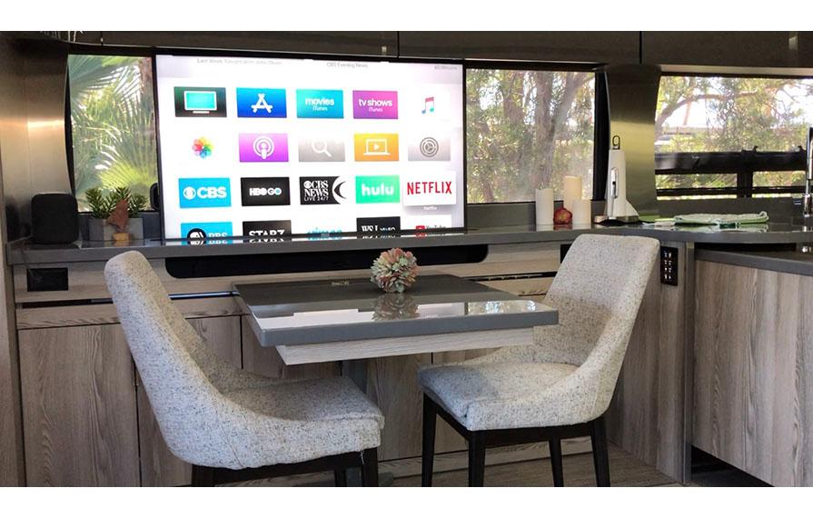 Dinette with two chairs placed next to TV